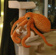 a stuffed octopus with a cat on top of it