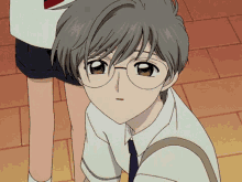 a boy wearing glasses and a white shirt