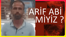 a man with a beard is standing in front of a sign that says ' arif abi miyiz '
