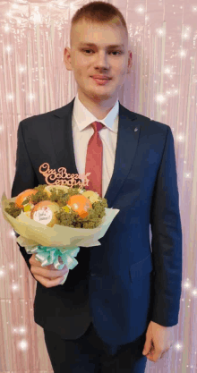 a man in a suit and tie holds a bouquet of fruits