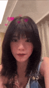 a girl with hearts in her hair is looking at the camera