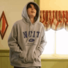 a man wearing a hoodie with the word nc17 on it