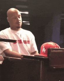 a man wearing a la hat is sitting at a piano