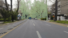 a blue bus is driving down a street with a green border