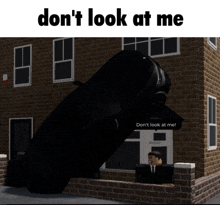 a brick building with a black car in front of it and the words " don 't look at me "