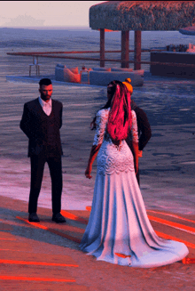 a bride and groom pose for a picture on the beach