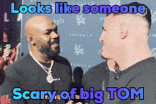 two men are standing next to each other and the caption says looks like someone scary of big tom