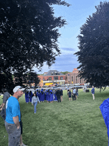 a group of graduates are gathered in a field