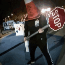 a person holding a stop sign with a cone on top of it