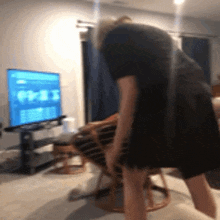 a blurry picture of a person bending over in front of a television