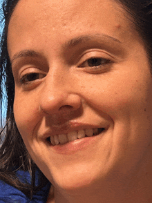 a close up of a woman 's face with a smile on it