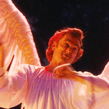 a man in a white shirt with wings on his arms