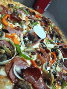 a pizza with lots of toppings including pepperoni mushrooms and onions