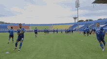 a group of soccer players on a field with one wearing a jersey that says ' persija ' on it