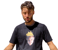 a man wearing a black t-shirt with a picture of a man 's face with french fries on his head