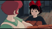 a girl with a red bow on her head is talking to a woman