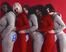 a group of women wearing sweatpants with the letter b on the side