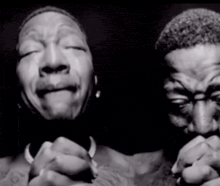 a black and white photo of a man and woman praying
