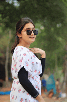 a woman wearing sunglasses and a shirt that has the word cool on it