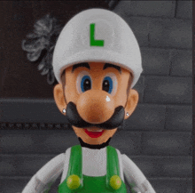 a mario figure with a white hat and a green letter l on his hat