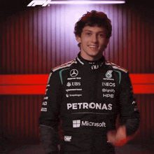 a man wearing a petronas jacket with microsoft on the front
