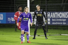 soccer players on a field with a sign that says xanthonis