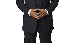 a man in a suit with his hands folded