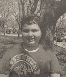 a young man wearing a t-shirt with a graphic on it