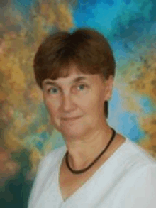 a woman wearing a white shirt and a black necklace is standing in front of a colorful background .