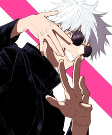 a man with white hair and sunglasses is making a peace sign with his hands