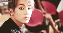 a close up of a person 's face with the words teen top on air visible