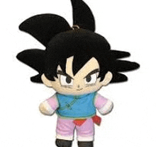 a stuffed toy of goku from dragon ball z is wearing a blue vest and pink pants .