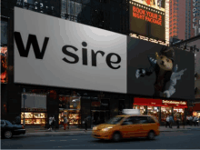 a billboard on a city street says w sire on it