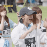 a woman wearing a ny hat and a shirt that says smack on it