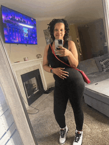 a woman taking a picture of herself in a mirror
