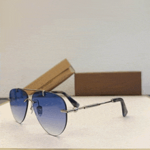 a pair of sunglasses made by louis vuitton sit on a table