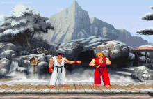 two karate fighters are standing on a wooden stage in front of mountains