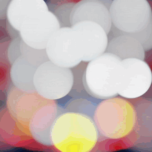 a bunch of white circles on a red and yellow background
