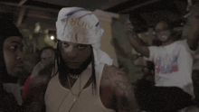 a man with a bandana on his head that says ' boii ' on it