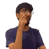 a man with glasses and a beard is pointing his finger