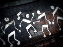 a brick wall with a drawing of a group of people dancing