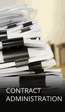 a stack of binders with the words contract administration written on the bottom