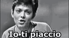 a black and white photo of a man with the words `` io ti piaccio '' written above him .