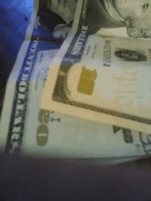 a twenty dollar bill is laying on top of another bill