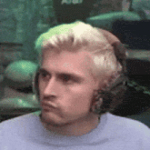 a close up of a man wearing headphones making a face