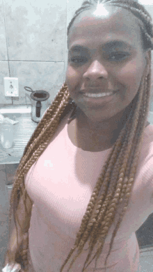 a woman with braids is smiling for the camera