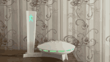 a white device with a green star on top of it sits in front of a floral wallpaper