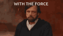 a man with a beard is pointing at something with the words with the force written above him