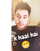 a man wearing a black shirt that says k haal hai on it