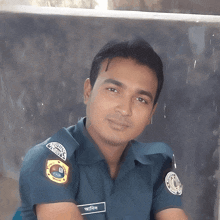 a man in a police uniform has a badge on his arm that says ' bangladesh police '